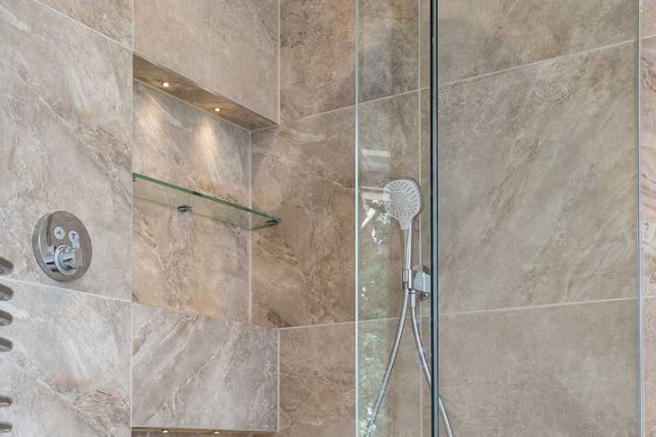 Frameless glass shower enclosure